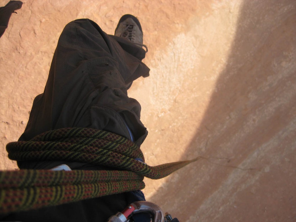 Looking down mid-rappel. Wrapping the rope around your leg a few times lets you hang hands-free while rappelling. Looking down mid-rappel. Wrapping the rope around your leg a few times lets you hang hands-free while rappelling.